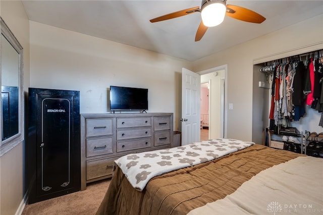 bedroom with a closet, light colored carpet, and ceiling fan