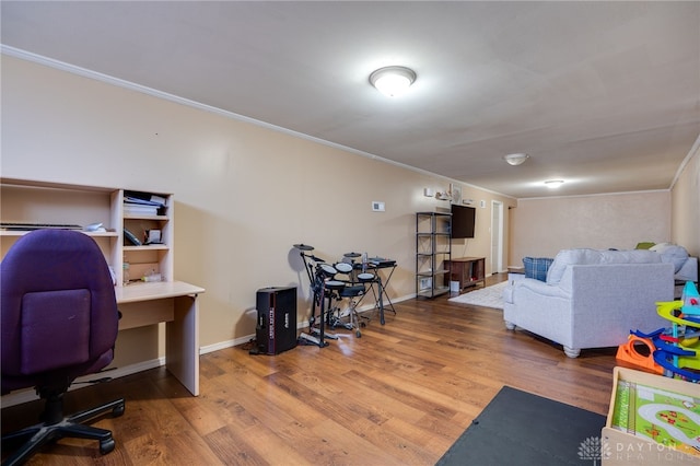 interior space featuring crown molding, baseboards, and wood finished floors