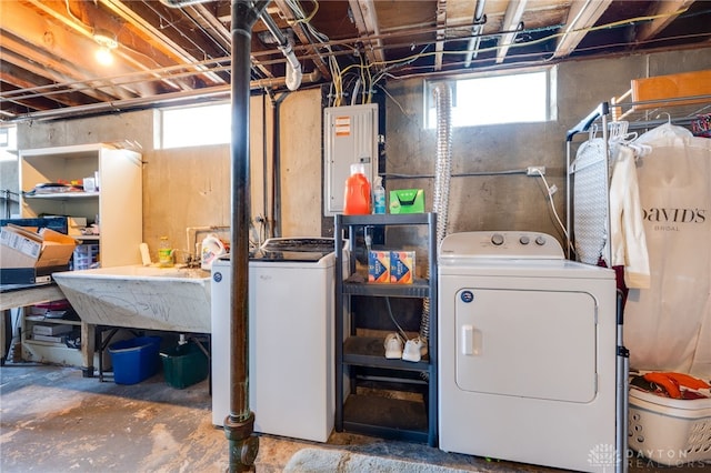 laundry area with laundry area, electric panel, and washing machine and clothes dryer