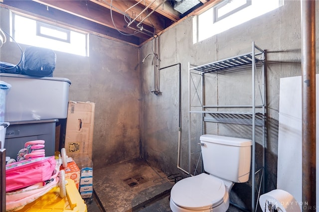 bathroom featuring toilet and a stall shower