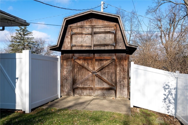 view of shed featuring fence