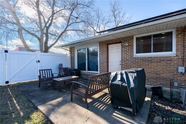 view of patio / terrace featuring fence and a gate