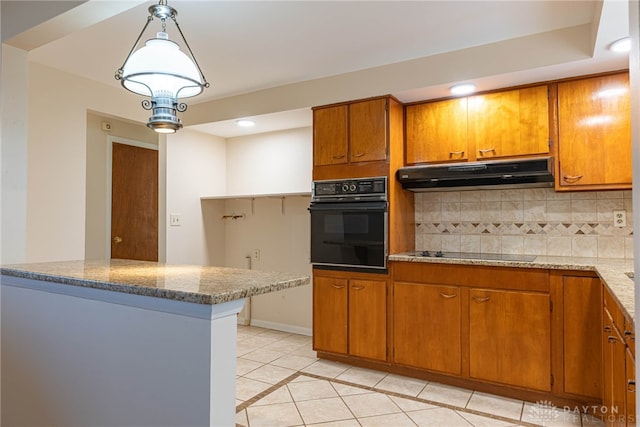 kitchen featuring pendant lighting, backsplash, light tile patterned floors, light stone counters, and black appliances