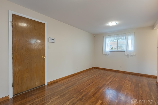 empty room featuring dark hardwood / wood-style flooring