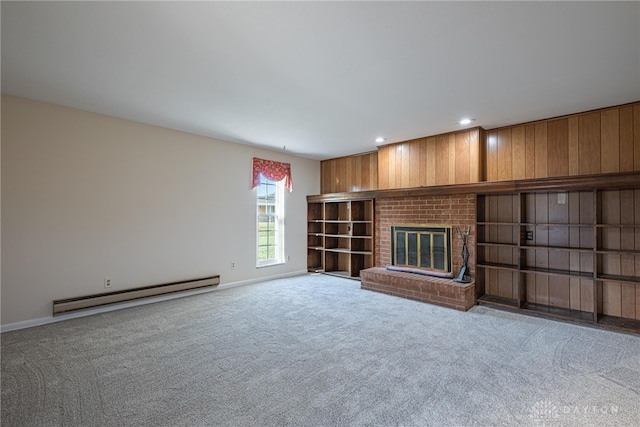 unfurnished living room featuring light colored carpet, a brick fireplace, and a baseboard heating unit