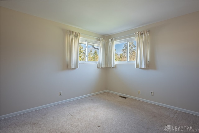 unfurnished room featuring carpet flooring