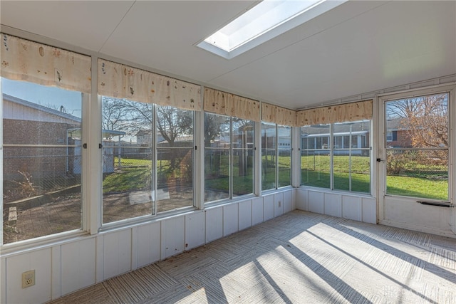 unfurnished sunroom featuring a skylight