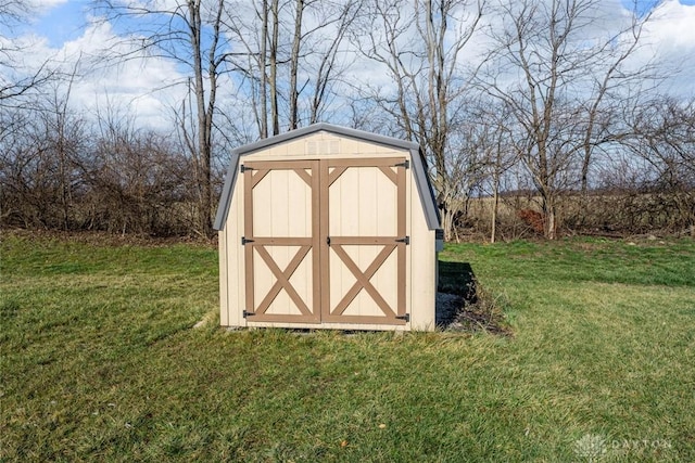 view of outbuilding with a yard