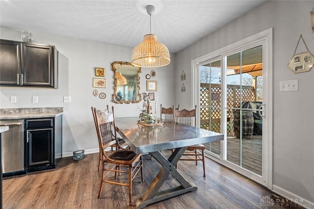 dining room featuring wood-type flooring and a textured ceiling