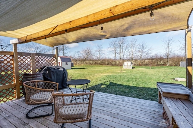 wooden terrace with a grill, a shed, and a lawn