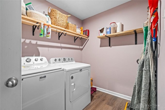 clothes washing area featuring dark hardwood / wood-style floors and washing machine and clothes dryer