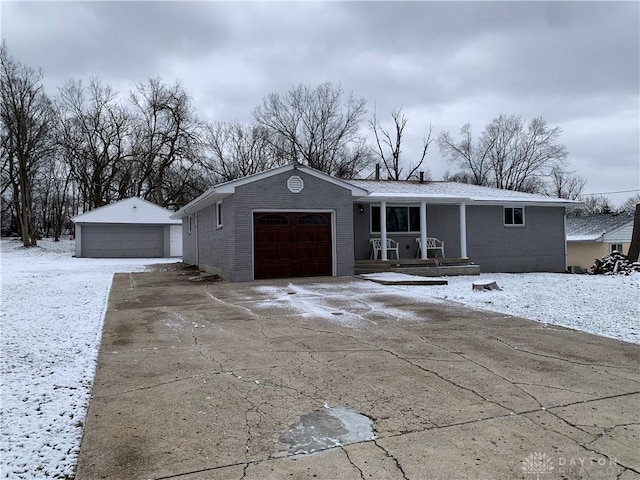 single story home with covered porch and a garage