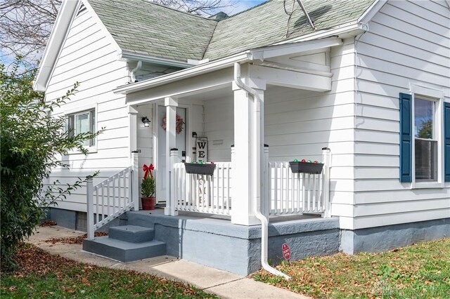 view of exterior entry featuring a porch