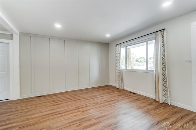 spare room featuring light hardwood / wood-style flooring