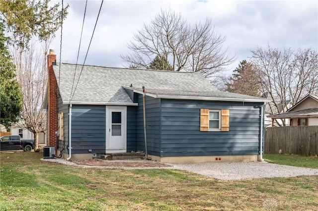 back of property with a yard and cooling unit