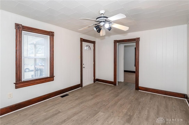 unfurnished room with ceiling fan and light wood-type flooring