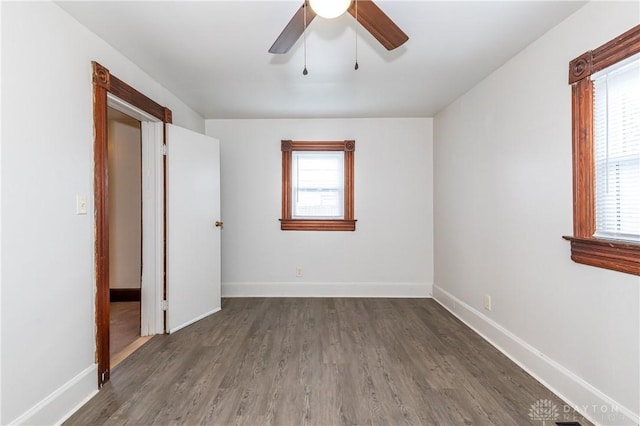 unfurnished bedroom featuring dark hardwood / wood-style floors and ceiling fan