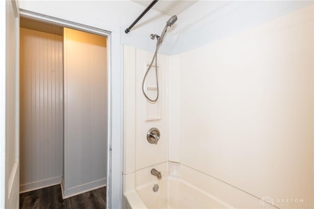 bathroom with bathtub / shower combination and hardwood / wood-style flooring