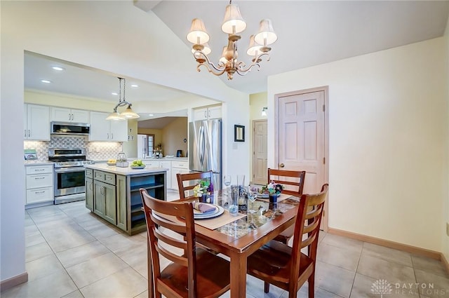 dining space featuring light tile patterned floors, lofted ceiling, and a notable chandelier