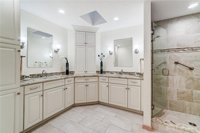 bathroom featuring vanity, tile patterned floors, and walk in shower