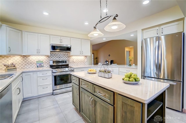 kitchen featuring stainless steel appliances, white cabinetry, and a kitchen island