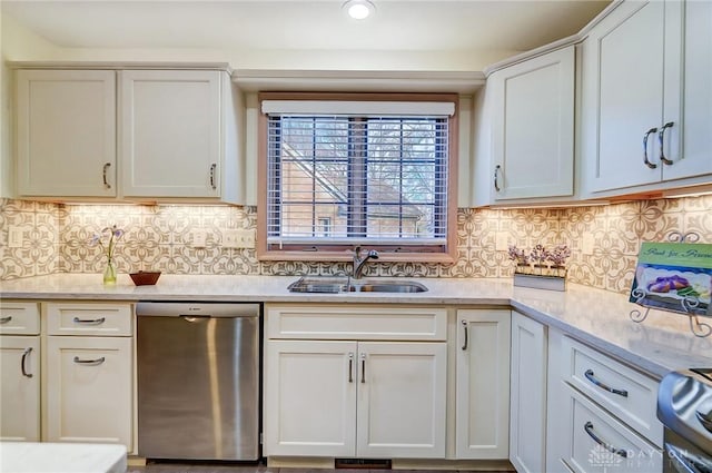 kitchen with dishwasher, stove, backsplash, sink, and white cabinetry