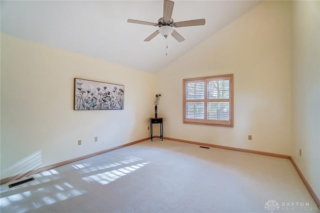 empty room featuring ceiling fan, carpet floors, and high vaulted ceiling