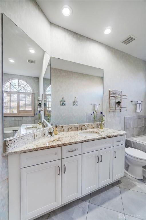 bathroom featuring tile patterned floors, vanity, and toilet