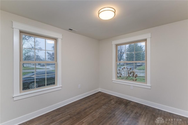 empty room with dark wood-type flooring