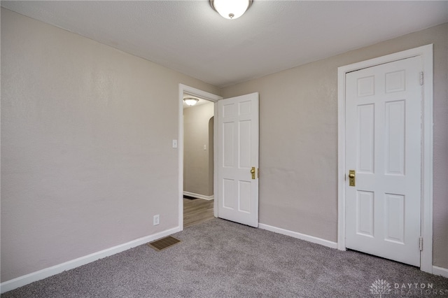 unfurnished bedroom featuring light carpet