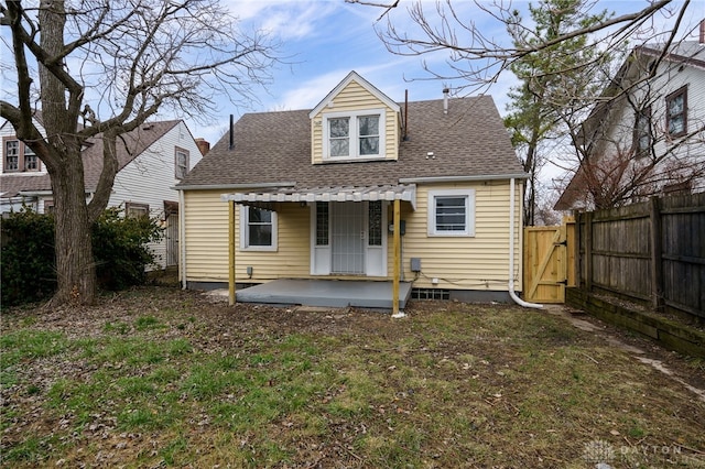 back of property featuring a patio area and a yard