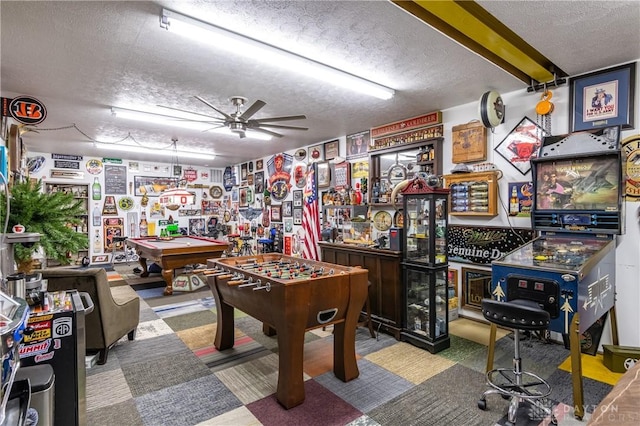 game room featuring ceiling fan, a textured ceiling, and pool table