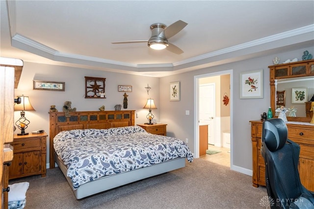 carpeted bedroom with a raised ceiling, ceiling fan, and ornamental molding