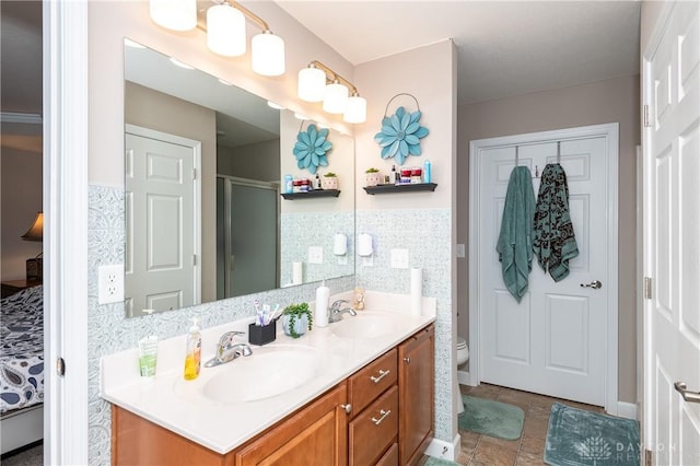 bathroom with vanity, toilet, and a shower with door