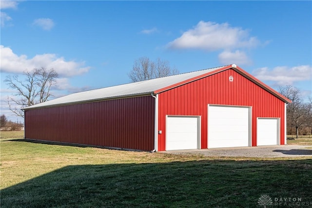 view of outbuilding featuring a yard and a garage