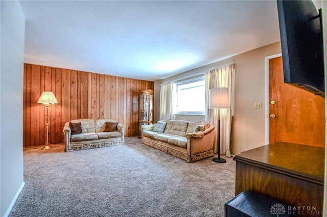 unfurnished living room with wooden walls and carpet floors