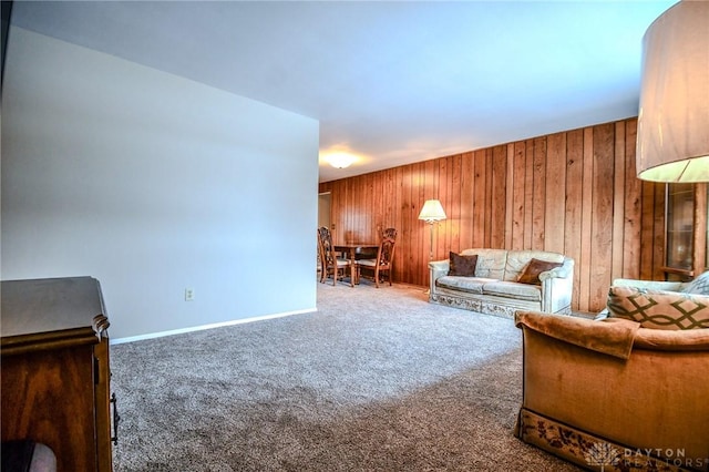 unfurnished living room with carpet and wooden walls