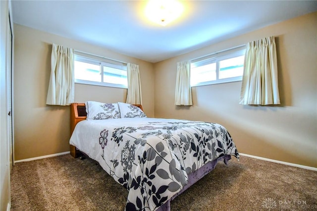 bedroom with dark colored carpet