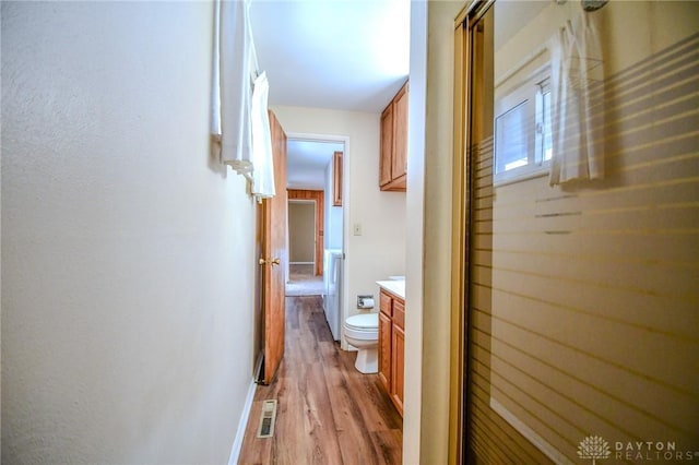 hallway with light hardwood / wood-style flooring