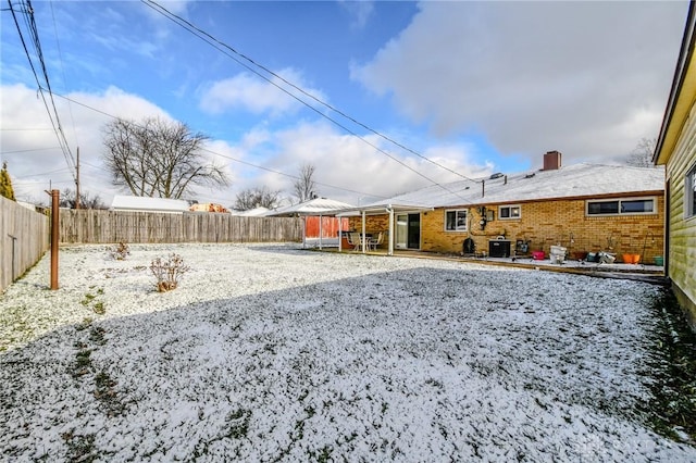 yard covered in snow featuring cooling unit