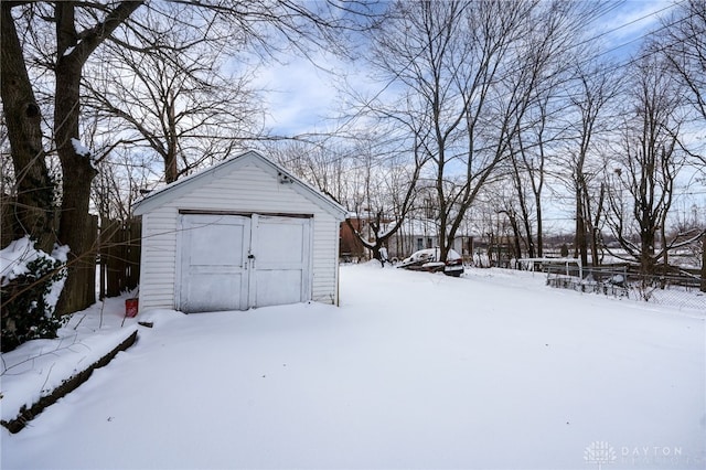 yard layered in snow featuring a storage shed