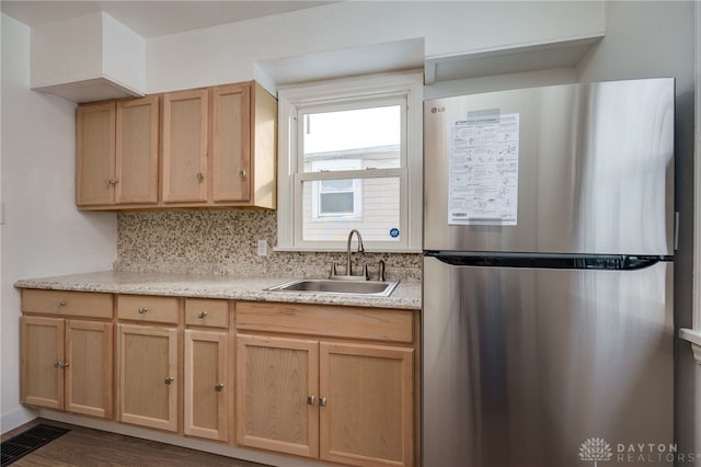 kitchen featuring stainless steel refrigerator, sink, dark wood-type flooring, decorative backsplash, and light brown cabinetry