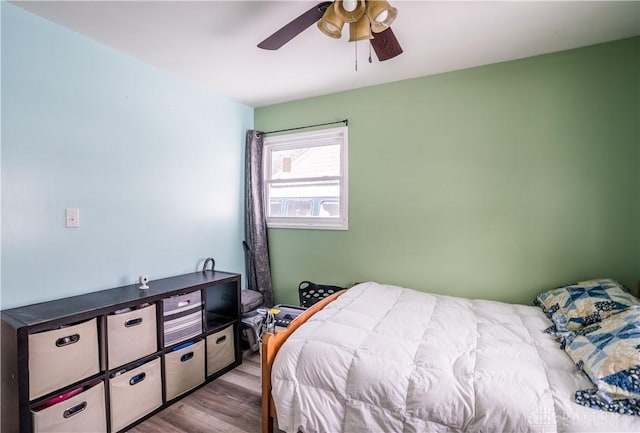 bedroom with light hardwood / wood-style flooring and ceiling fan