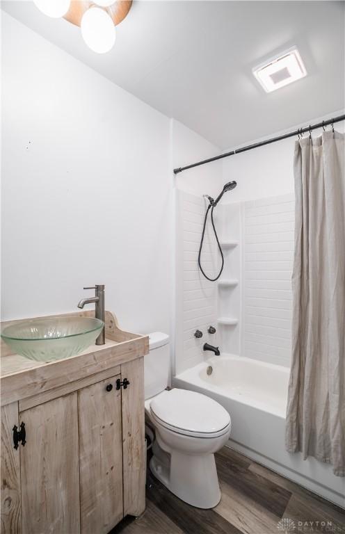 full bathroom featuring shower / bath combo, vanity, toilet, and hardwood / wood-style floors