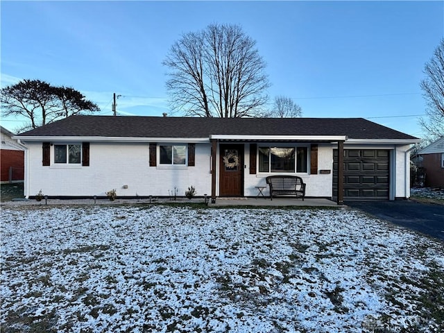 single story home with covered porch and a garage