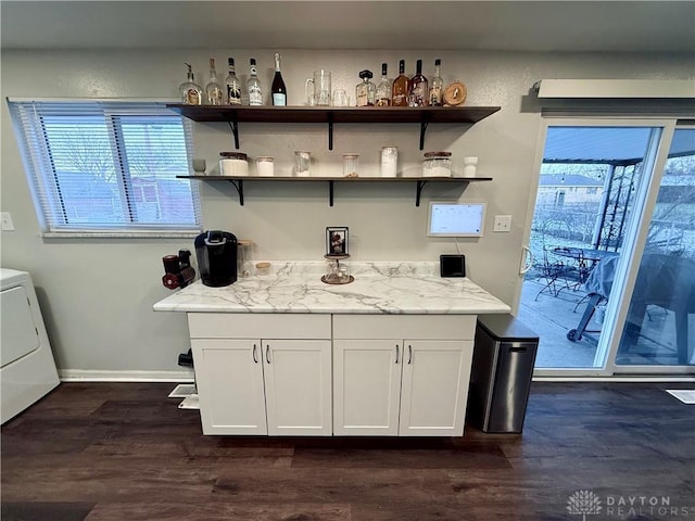 bar with white cabinets, washer / dryer, light stone counters, and plenty of natural light