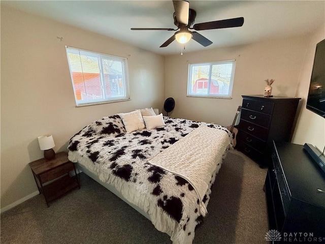 carpeted bedroom featuring multiple windows and ceiling fan