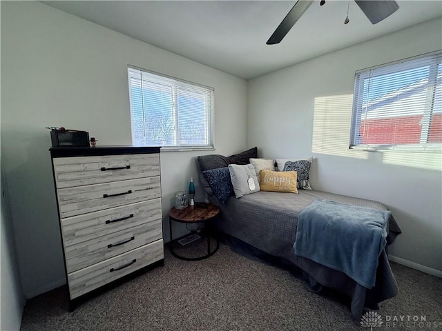 bedroom with dark colored carpet and ceiling fan