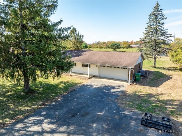 view of front of property with a garage and central air condition unit