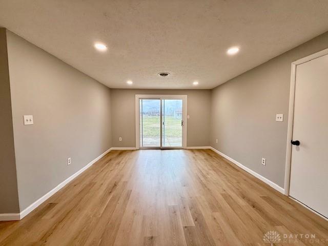 unfurnished room with light hardwood / wood-style flooring